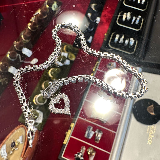 Silver and 10k diamond bracelet with heart charm on a jewelry display box at Saugerties Antiques Center.