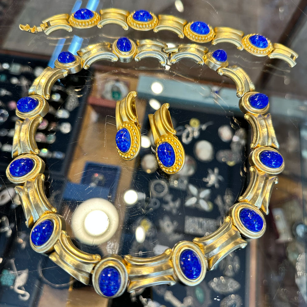 Gold and blue gemstone jewelry set on a glass jewelry case at an antique store in Saugerties Upstate NY.