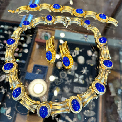 Gold and blue gemstone jewelry set on a glass jewelry case at an antique store in Saugerties Upstate NY.