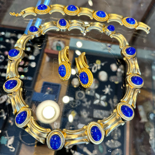 Gold and blue gemstone jewelry set on a glass jewelry case at an antique store in Saugerties Upstate NY.