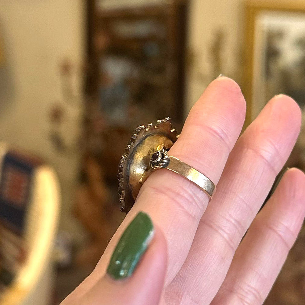 Underside of a 1920s cameo ring in gold with a flip side.