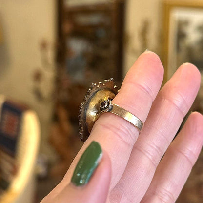 Underside of a 1920s cameo ring in gold with a flip side.